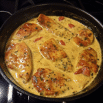 Golden seared Marry Me Chicken in a creamy Parmesan sauce with sun-dried tomatoes and fresh herbs in a cast iron skillet