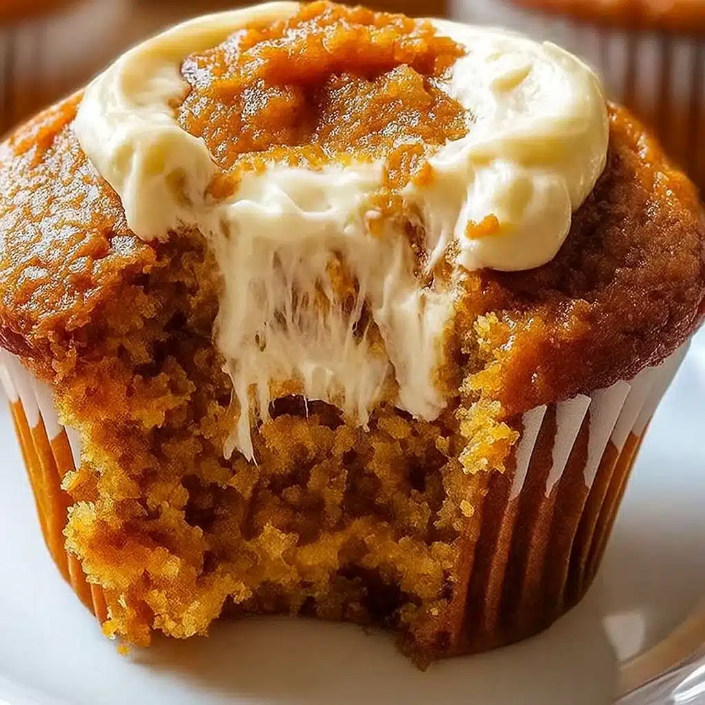 Golden pumpkin cream cheese swirl muffins with beautiful marbled cream cheese ribbons on a rustic wooden board, surrounded by fall leaves and cinnamon sticks