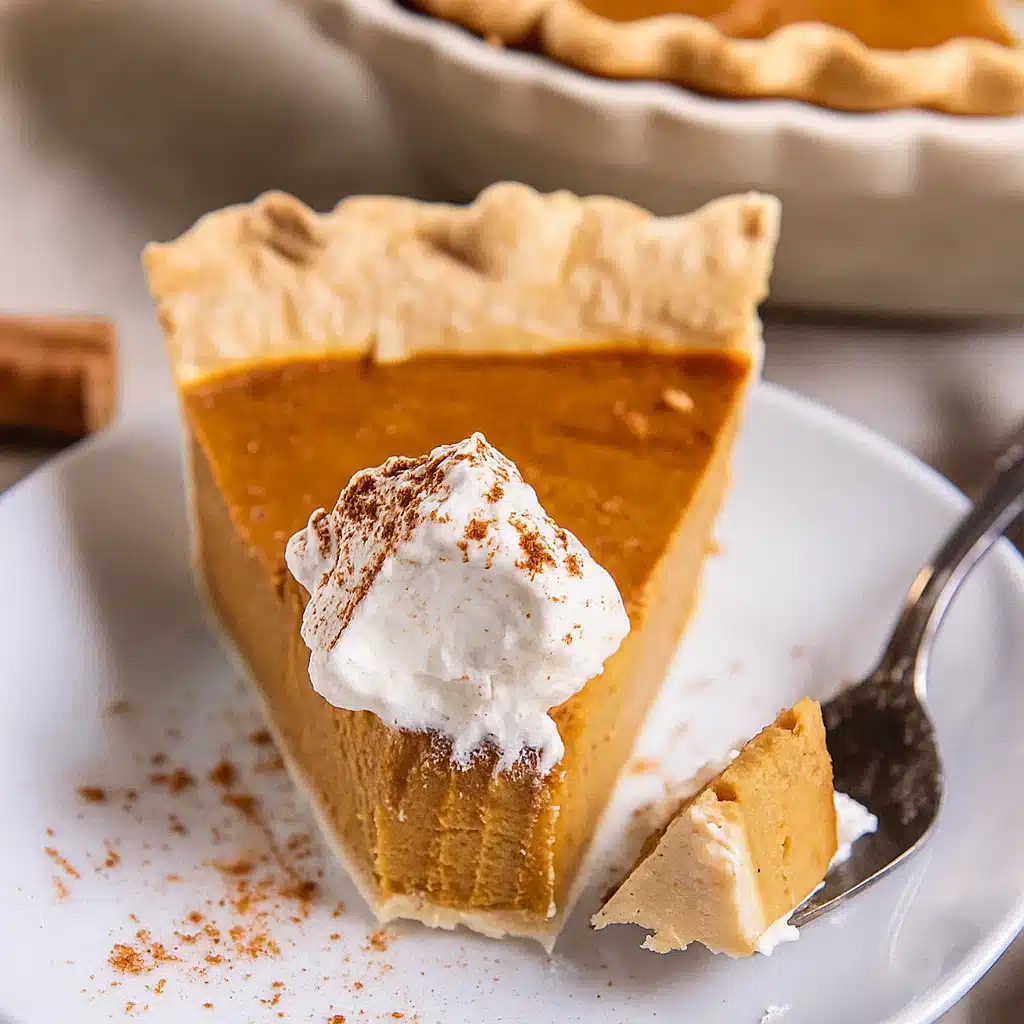 Golden brown pumpkin pie with flaky crust, garnished with sugared cranberries and whipped cream, served on a rustic wooden table with fall decorations