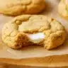 Soft, golden-brown pumpkin Cheesecake cookies rolled in cinnamon sugar with a creamy white cream cheese filling visible in the center