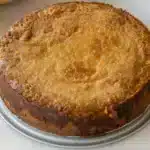Golden brown pumpkin gooey butter cake cut into squares showing the creamy, gooey pumpkin filling on top of a tender cake crust base