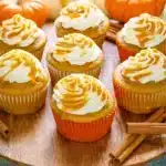 Golden pumpkin spice Caramel cupcakes topped with swirled cream cheese frosting, drizzled with caramel sauce and sprinkled with flaky sea salt