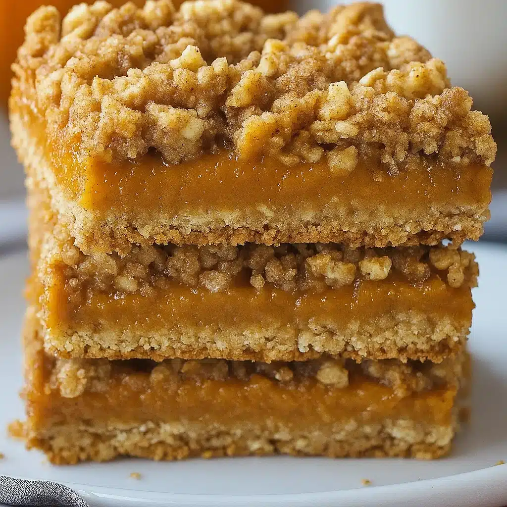Golden brown pumpkin pie crumble bars with buttery streusel topping and creamy spiced pumpkin filling, cut into perfect squares