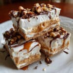 Peanut butter frozen yogurt bars with chocolate peanut butter cup pieces, sliced and arranged on parchment paper